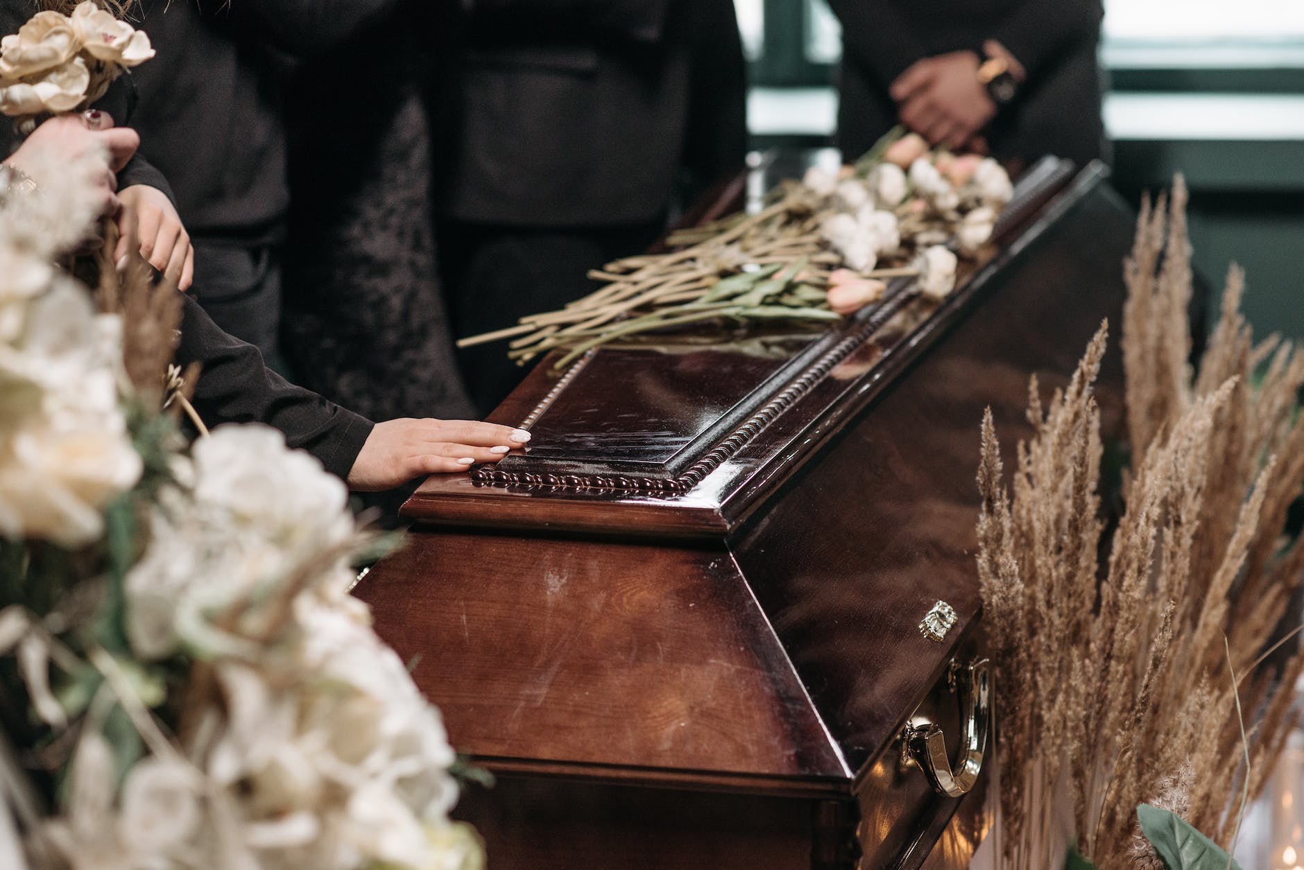 a person holding a wooden coffin